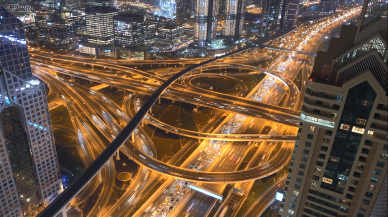 Aerial view of busy crisscrossing highway at night.