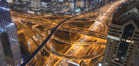 Aerial view of busy crisscrossing highway at night.