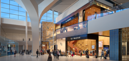 An image of the La Maison retail outlet inside JFK Airport's New Terminal One, with passengers walking past.