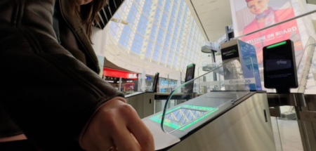 A passenger at Sofia Airport uses an automatic boarding card scanner.