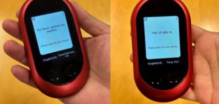 Two handheld TSA translation devices on a yellow background.
