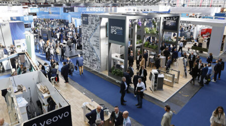 An aerial shot of a busy expo floor with blue carpet.