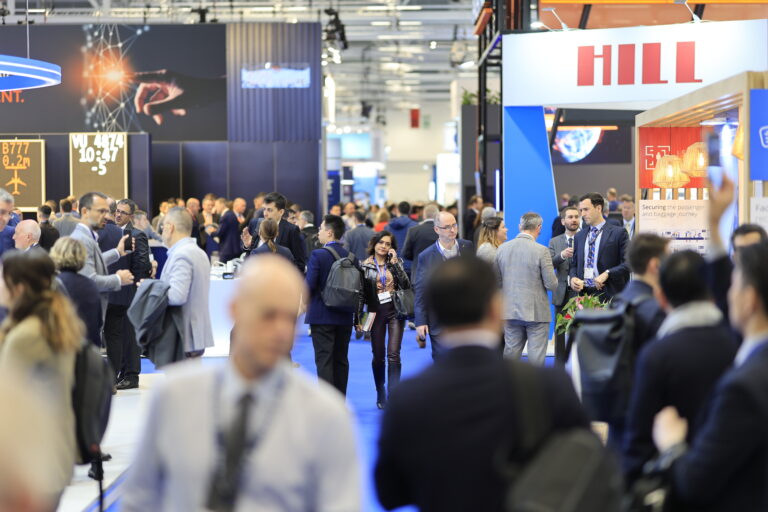 SHOW REVIEW: Passenger Terminal Expo 2024 A woman walks through a busy expo hall.