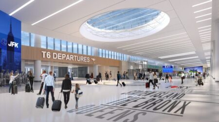 A render of the inside of JFK Airport’s Terminal 6, with passengers walking through to a sign that says “T6 Departures”.