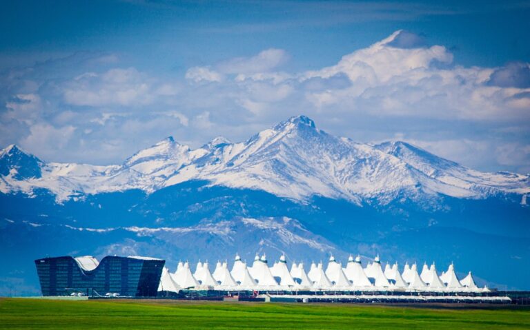 Daifuku announces checkpoint screening contract for Denver A shot of the exterior of Denver International Airport with mountains in the background.