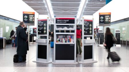 Heathrow relaunches Fast Track Security service Passengers walk past the information signs at Heathrow security.