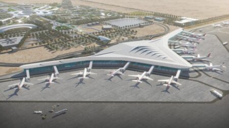 An aerial render of Libya’s Benghazi Airport shows 12 airplanes parked outside a triangular airport terminal.
