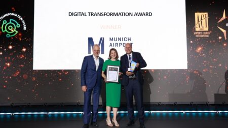 Munich Airport wins Digital Transformation Award Andreas Boschen, executive director SESAR 3 Joint Undertaking; Vera Jakobsen, vice president digital of Munich Airport; and Dr Jan-Henrik Andersson, chief commercial officer and chief security officer of Munich Airport stand on a stage to accept the Digital Transformation Award at the inaugural ACI Europe Best Airport Awards.