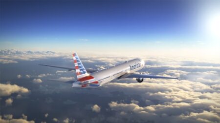An American Airlines aircraft flies above the clouds
