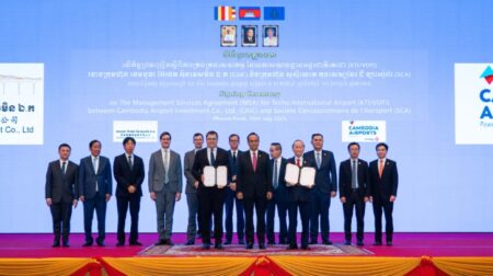 Cambodia Airports to operate Techo Airport A group of executives in suits line up along a blue wall with small writing.