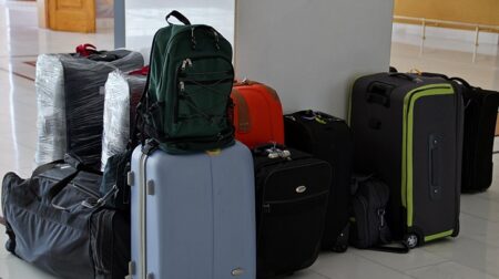 Passenger luggage piles up in the corner.