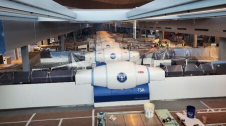 12 rows of security screening technology are unwrapped by staff at Pittsburgh International Airport’s new terminal.