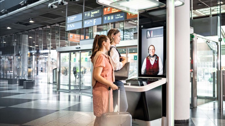 Two passengers face an airport e-gate.