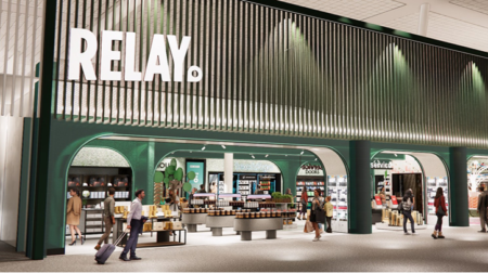 Passengers wander in and out of an airport shop with the word "Relay" plastered on the wall.
