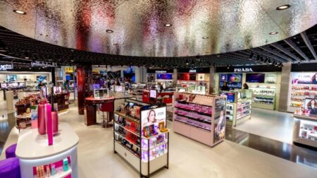 The flagship store for the new duty free retail concept Today Duty Free at Schiphol airport, with rows of cosmetics to purchase.