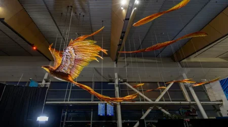 Wellington unveils latest terminal showpiece The new illuminated artwork sculpture, in orange, yellow and red, hangs from the ceiling at Wellington Airport in New Zealand
