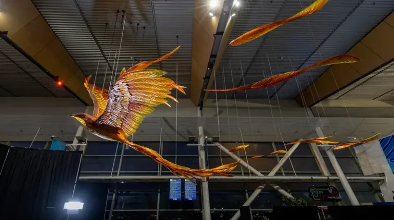 Wellington unveils latest terminal showpiece The new illuminated artwork sculpture, in orange, yellow and red, hangs from the ceiling at Wellington Airport in New Zealand