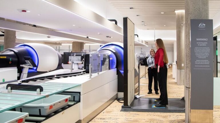Brisbane upgrades security screening A passenger in black trousers and a red top walks through the new screening technology at the upgraded Domestic Terminal at Brisbane Airport