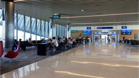 LAX Terminal 5 with passengers sitting at gates waiting for flights
