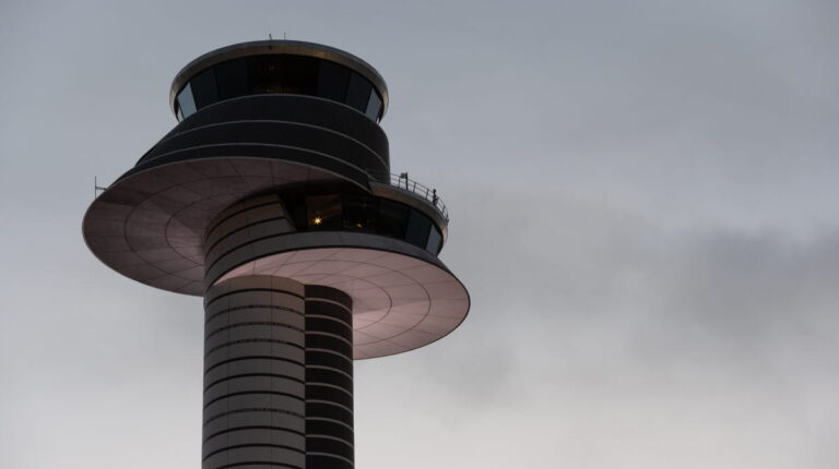 Stockholm Arlanda introduces new air traffic approach concept to boost efficiency and sustainability An air traffic control tower against a grey, cloudy sky
