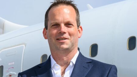 Profile photo of Jonny Macneal against the white exterior of an aircraft