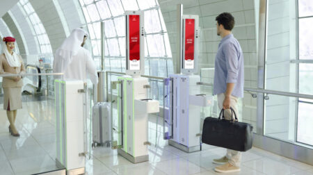 Passengers use a facial recognition solution at an airport