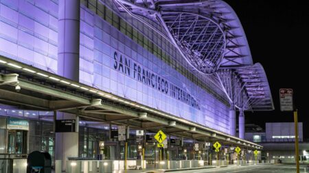 San Francisco International to close Runway 1R for six months in 2026 for repaving works Exterior of San Francisco Airport at night, with the name of the airport lit up.