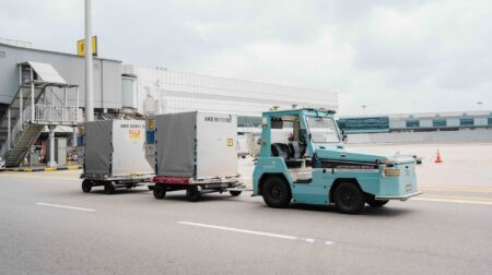Changi Airport deploys autonomous tractors in airside baggage operations A turquoise driverless tractor deployed airside at Changi Airport.