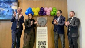 Airport and local authority representatives attend a ceremony marking the LEED Platinum recertification of Terminal 4 at JFK Airport.