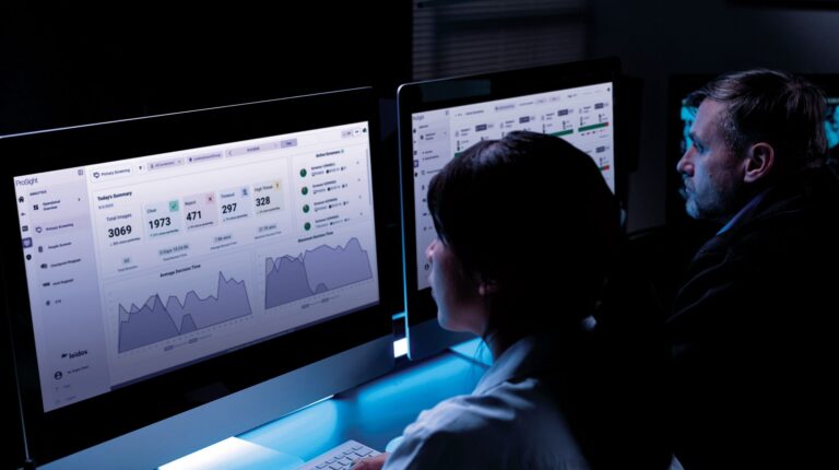A cybersecurity expert works at a bank of computer screens.