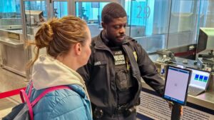 CBP official assists a passenger with enhanced passenger processing at Philadelphia International Airport.