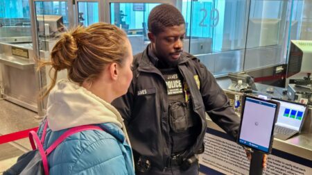 CBP official assists a passenger with enhanced passenger processing at Philadelphia International Airport.
