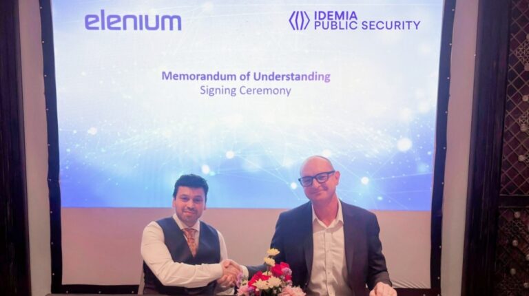 Aaron Hornlimann, co-founder and CEO of Elenium, and Tim Ferris, global head, travel and transport at IDEMIA Public Security, shake hands at the signing of an MoU between IDEMIA and Elenium on biometric, digital IDs.
