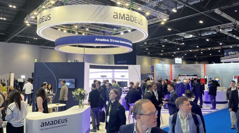 Amadeus signage hangs over the exhibition hall at PTE World expo in London.