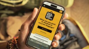 A passenger looks at the 'Pack Right. Safe Flight' mobile app on their smartphone.