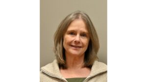 Headshot of Chris Morello, airport executive director at Monterey Regional Airport, against a light brown background.
