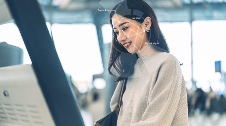 A female passenger uses a contactless check-in booth at an airport.