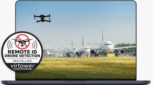 A drone flies over an airport with aircraft queueing in a line.