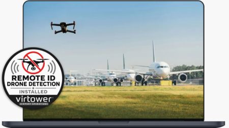 A drone flies over an airport with aircraft queueing in a line.