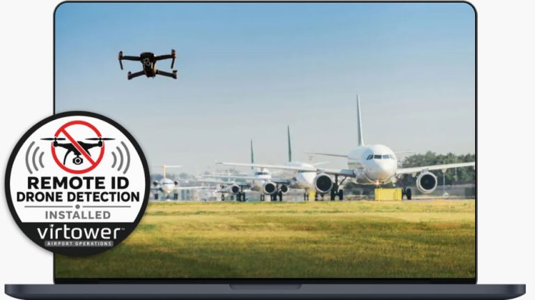 A drone flies over an airport with aircraft queueing in a line.