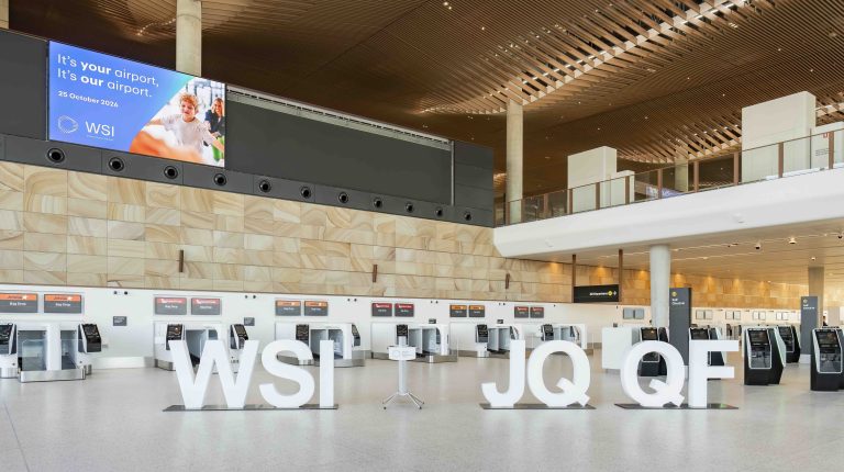 WSI lettering in white placed on the concourse of a terminal at the new Western Sydney International Airport.