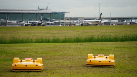 Autonomous robot mowers cutting the grass at Brisbane Airport.
