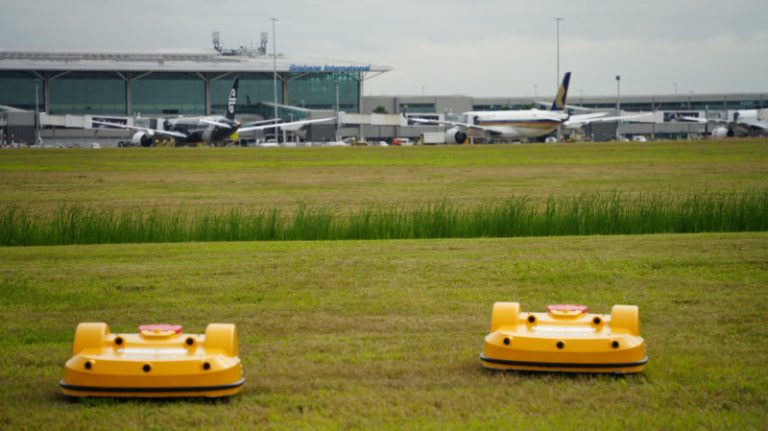 Autonomous robot mowers cutting the grass at Brisbane Airport.