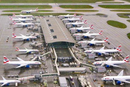 Aerial view of a row of British Airways planes parked at Terminal 5 at Heathrow Airport.