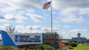 External front of Green Bay Austin Straubel International Airport, with an American flag flying.