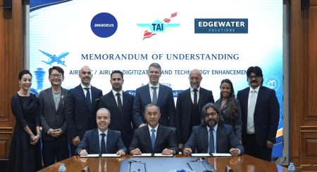 Representatives of Thai Aviation Industries, Edgewater Solutions and Amadeus at a table where the MoU is signed.