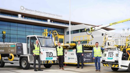 Western Sydney Airport publishes sustainability and net-zero strategy Representatives of Western Sydney Airport stand on the tarmac among ground operations equipment, wearing yellow high-vis jackets.