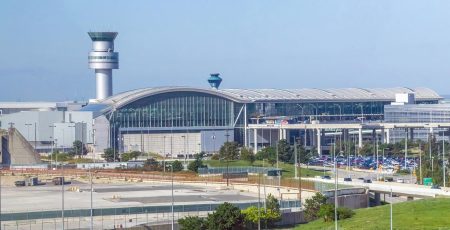 External view of Ontario International Airport wit the control tower visible in the left hand side of the photo.