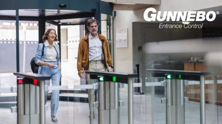 Assa Abloy to acquire Gunnebo Entrance Control Two passengers walk through a security e-gate at an airport with Assa Abloy to acquire Gunnebo Entrance Control logo on the top right corner.