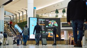 The concourse of one of the terminals at London Gatwick Airport in the UK, with passengers walking to their departure gates.